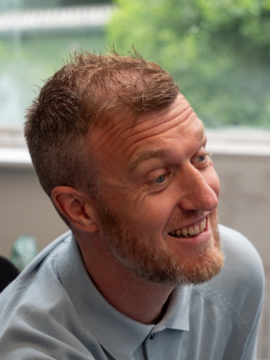 Jamie of Aspire Estates, smiling at his desk