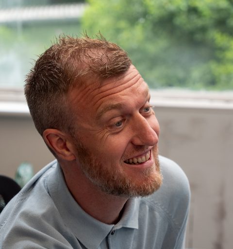 Jamie of Aspire Estates, smiling at his desk